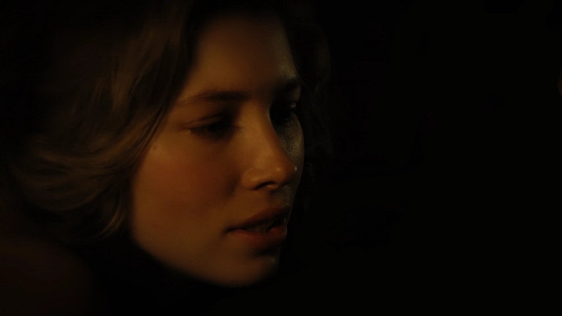 HD desktop wallpaper featuring a close-up portrait of celebrity Jessica Biel with a dark, moody background.