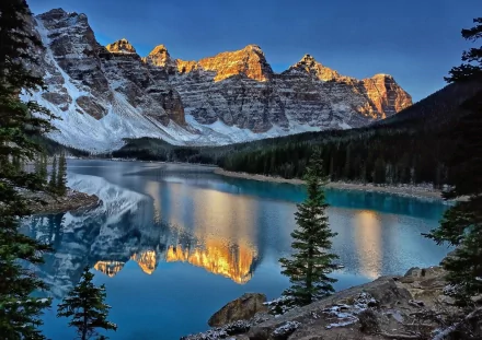 Stunning view of Moraine Lake in the Valley of the Ten Peaks, surrounded by majestic mountains and lush trees, with a clear reflection on the tranquil water. A beautiful scene from Banff National Park, Canada.