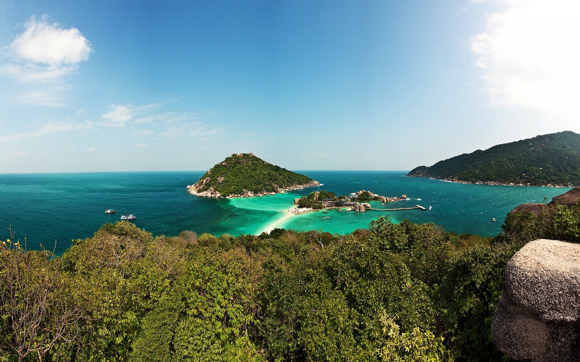 HD PC desktop wallpaper featuring a vibrant tropical nature scene with lush greenery, turquoise waters, and distant islands under a clear blue sky.