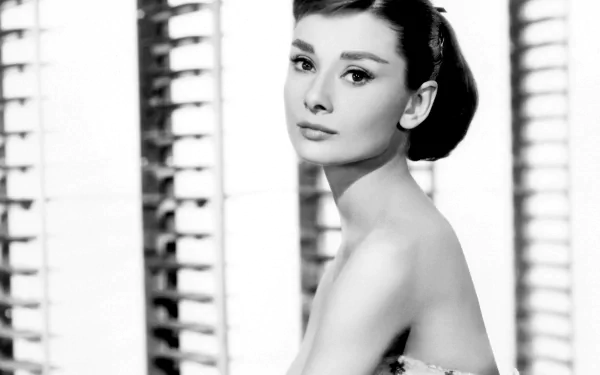 Black and white HD desktop wallpaper featuring a classic portrait of celebrity Audrey Hepburn with elegant makeup and hairstyle.
