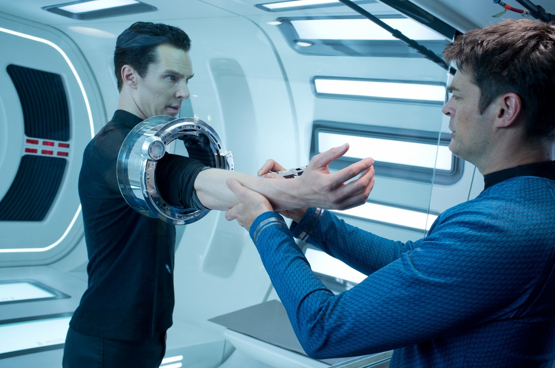 HD PC desktop wallpaper depicting a scene from the movie Star Trek Into Darkness, featuring two characters in a futuristic setting with advanced technology.
