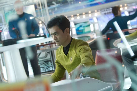 HD PC desktop wallpaper featuring a scene from the movie Star Trek Into Darkness, showing a focused crew member in a futuristic starship setting.