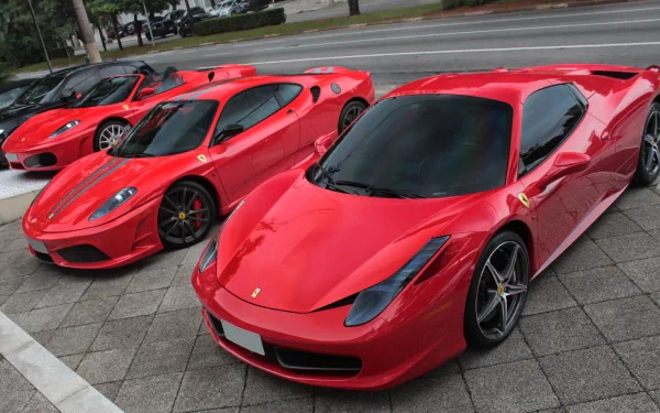 HD PC desktop wallpaper featuring a lineup of vibrant red Ferrari sports cars parked on a city street.
