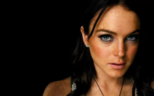 HD PC desktop wallpaper featuring a close-up portrait of celebrity Lindsay Lohan against a dark background.