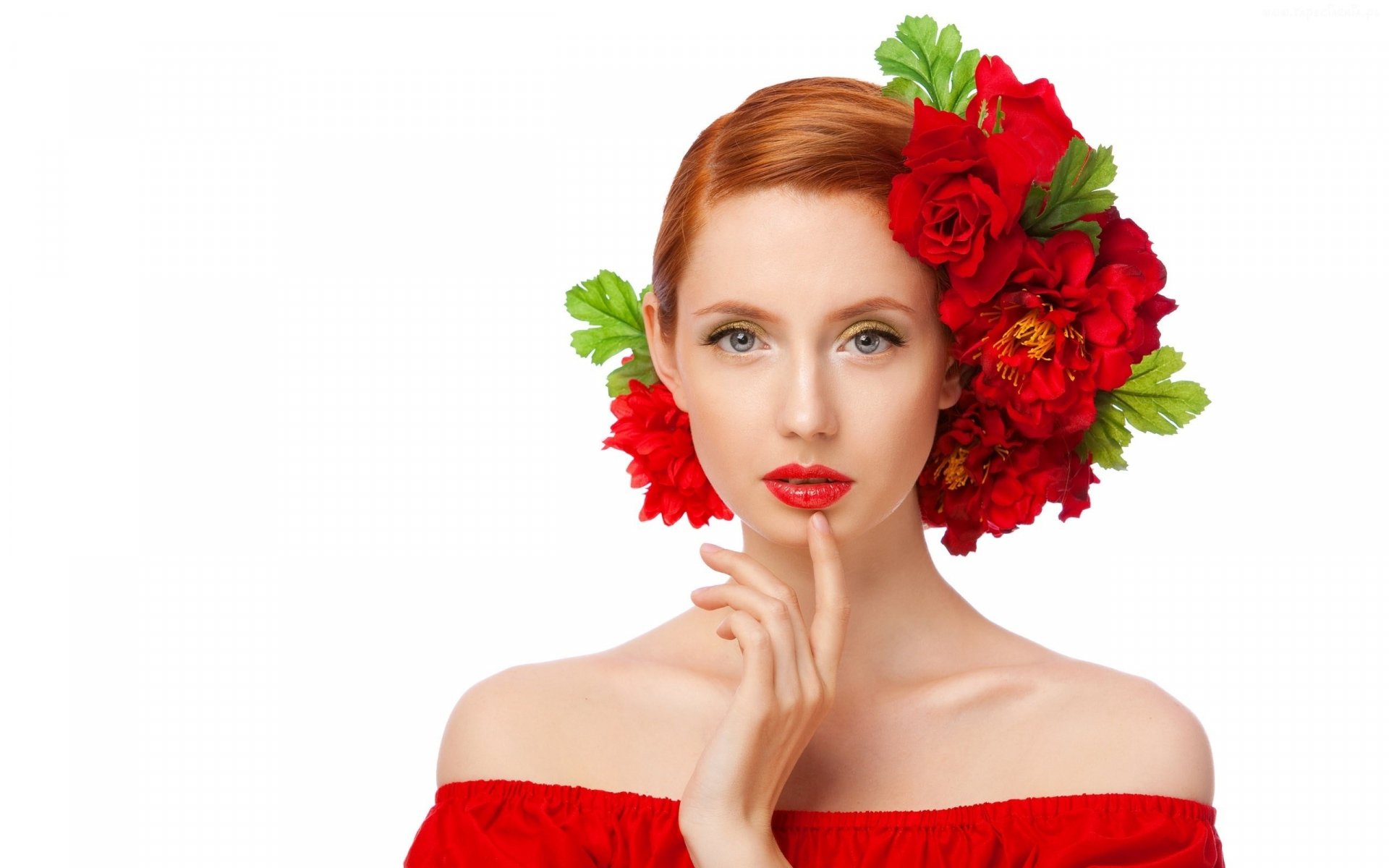 A woman with striking red hair and vibrant flowers poses elegantly. Her soft expression and floral accents create a captivating aesthetic for an HD desktop wallpaper.