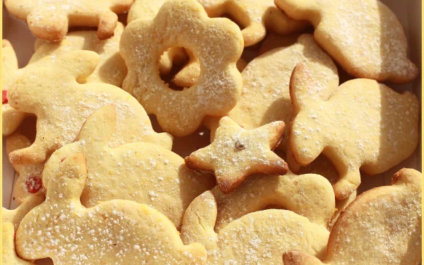 Close-up of various shaped cookies dusted with powdered sugar, captured in sharp detail for a 4K Ultra HD PC desktop wallpaper background.
