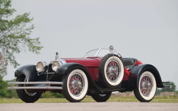 Red 1924 Duesenberg Model A Speedster with whitewall tires on a road, framed as an HD PC desktop wallpaper background.