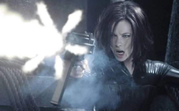 HD PC desktop wallpaper featuring a dramatic scene from the movie Underworld: Evolution, depicting a fierce woman firing a gun amidst smoke and dark surroundings.
