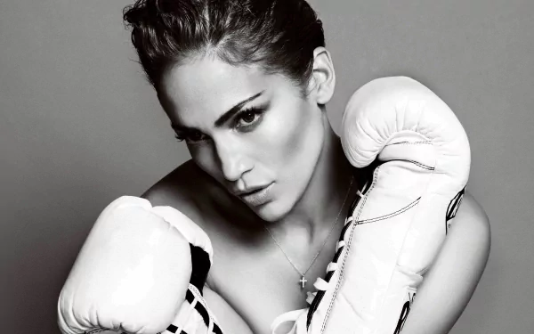 Black and white HD desktop wallpaper of celebrity Jennifer Lopez wearing boxing gloves, striking a fierce and confident pose.