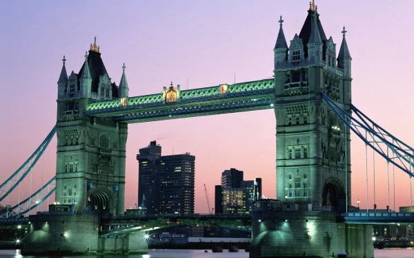 HD desktop wallpaper featuring London’s iconic man-made Tower Bridge illuminated against a twilight sky.