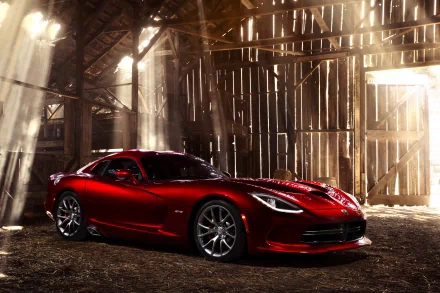 A red Dodge Viper SRT is showcased inside a rustic barn with sunlight streaming through wooden beams, captured as an HD PC desktop wallpaper and background.