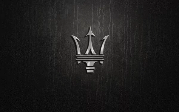 An elegant HD wallpaper featuring the iconic Maserati logo against a dark, textured background, showcasing the brand's luxurious and sporty essence.