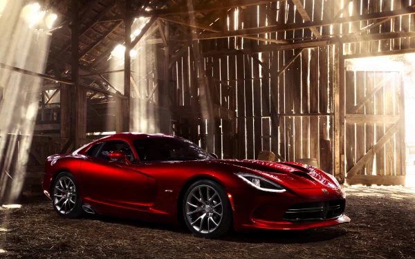 A red Dodge Viper SRT is showcased inside a rustic barn with sunlight streaming through wooden beams, captured as an HD PC desktop wallpaper and background.