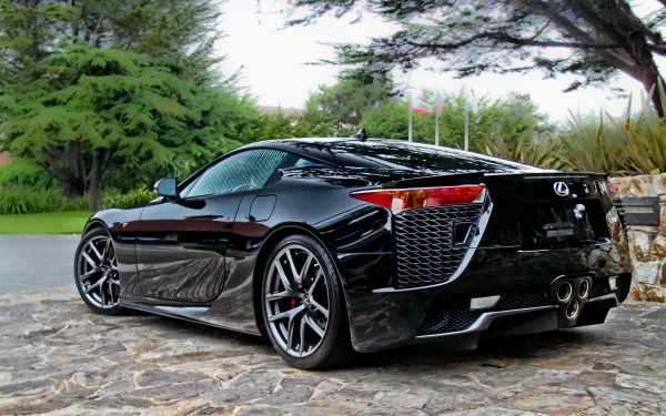 Sleek black Lexus LFA Nurburgring Edition parked on a stone driveway surrounded by greenery, captured in stunning 4K Ultra HD for PC desktop wallpaper.