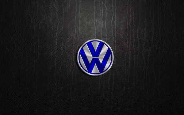 A sleek HD desktop wallpaper featuring the iconic Volkswagen logo on a textured black background, showcasing the brand's automotive legacy.