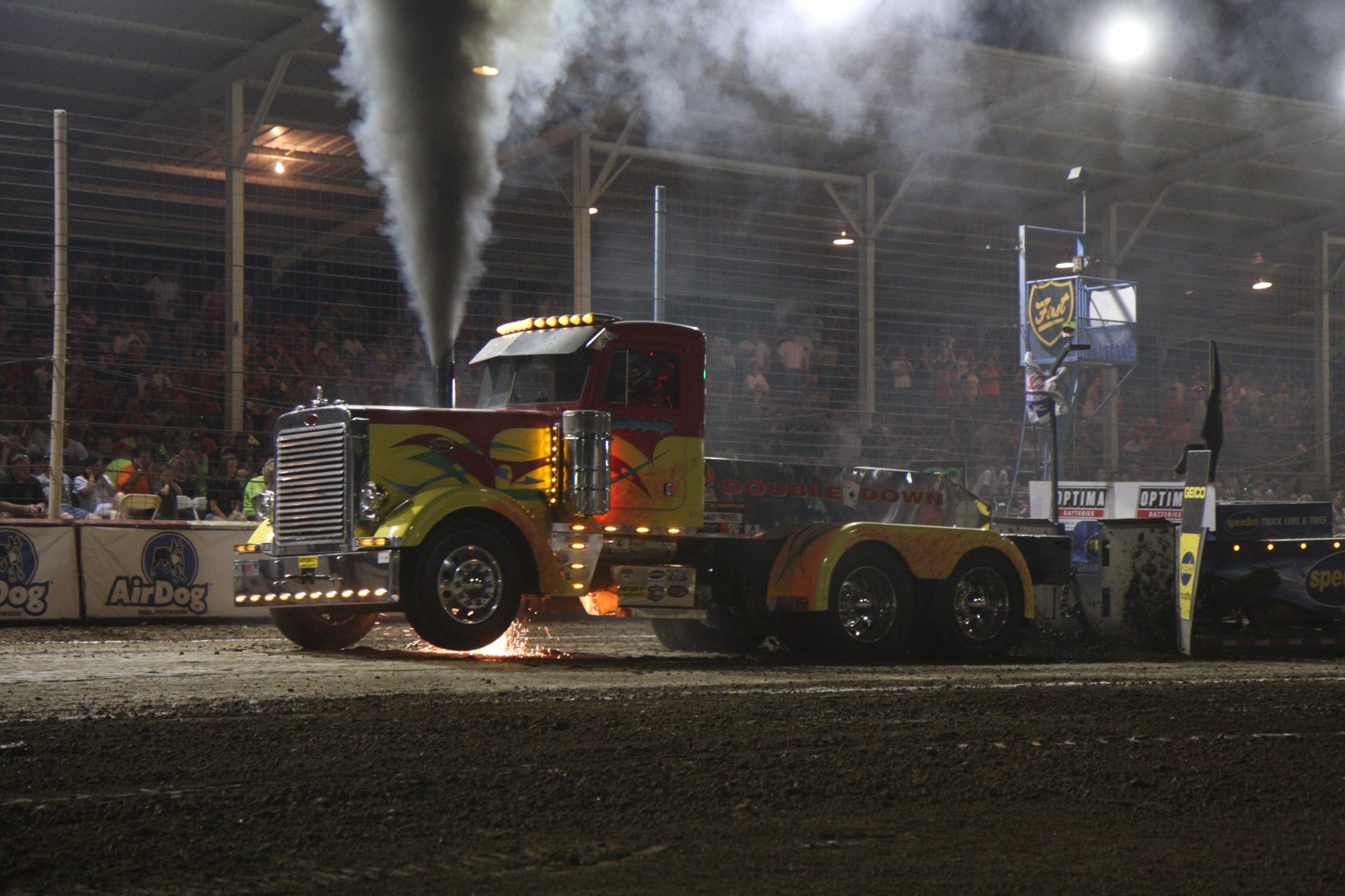4K Ultra HD PC desktop wallpaper and background of a painted Peterbilt truck in an indoor truck pull, exhaust plumes rising under arena lights.