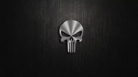 A sleek, metallic Punisher skull emblem against a dark textured background, creating a striking HD desktop wallpaper for comic enthusiasts.