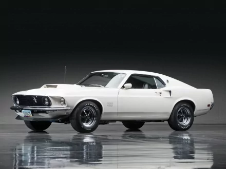 White Ford Mustang Boss 429 fastback muscle car showcased in a sleek studio setting, featured as an HD desktop wallpaper and background.