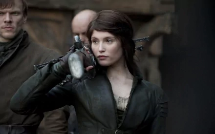 HD PC desktop wallpaper from the movie Hansel & Gretel: Witch Hunters featuring a focused woman holding a crossbow in a dark, medieval setting.
