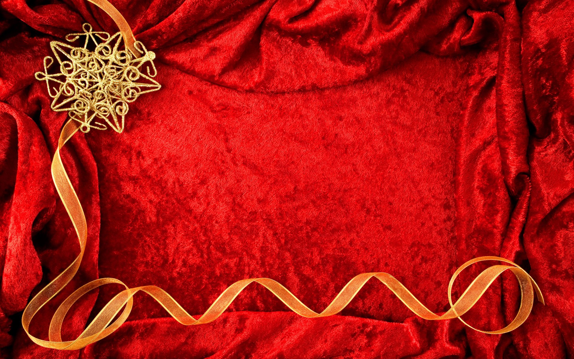 Artistic HD PC desktop wallpaper featuring a luxurious red velvet background with a gold intricate ornament and flowing ribbon for an elegant touch.