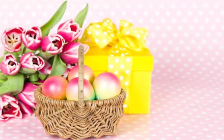 A cheerful Easter scene featuring a woven basket of colorful eggs next to a yellow gift box with a bow, complemented by a bouquet of pink tulips against a polka dot background.