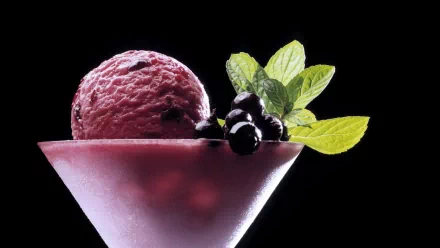 HD wallpaper of a delicious purple ice cream scoop in a frosted glass, garnished with fresh berries and mint leaves against a black background.