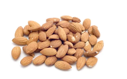 A close-up view of a pile of almonds on a white background, showcasing their natural textures. This image serves as a vibrant HD desktop wallpaper and background for food enthusiasts.