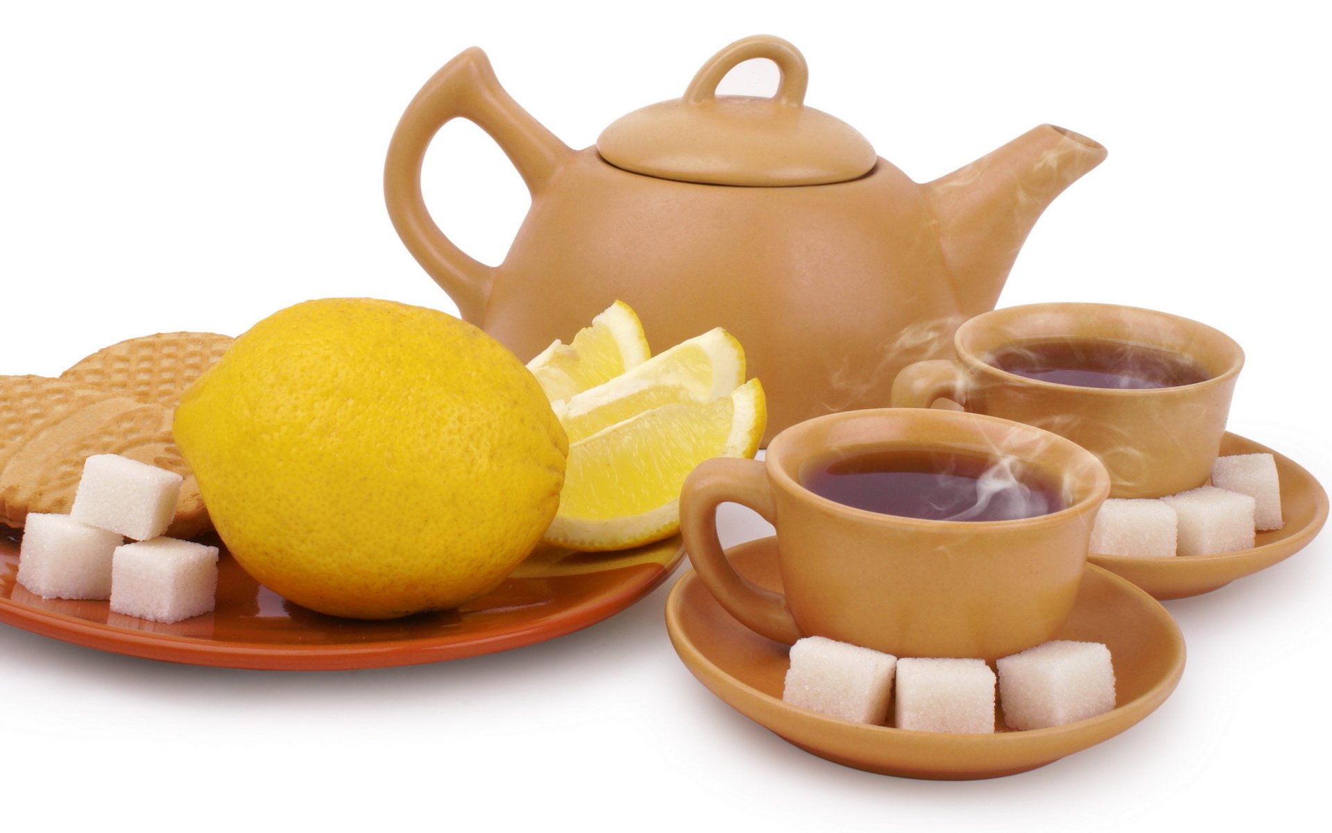HD desktop wallpaper featuring a tea set with steaming cups, a teapot, lemon slices, sugar cubes, and biscuits arranged on a white background.