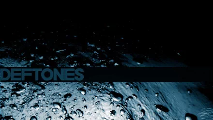 HD PC desktop wallpaper featuring a dark, moody background with water droplets and the band name Deftones in bold text, evoking a music-themed atmosphere.