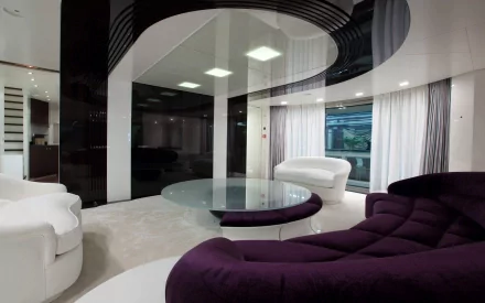 A modern, stylish room featuring sleek furniture in white and purple, large windows with sheer curtains, and a circular glass table, creating an inviting atmosphere for a HD desktop wallpaper.