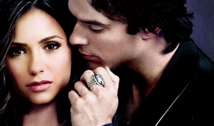 HD desktop wallpaper featuring characters from The Vampire Diaries, showcasing an intimate moment between two lead characters with a dramatic backdrop.