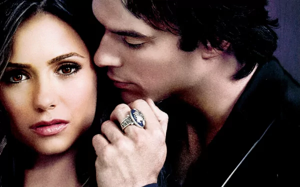 HD desktop wallpaper featuring characters from The Vampire Diaries, showcasing an intimate moment between two lead characters with a dramatic backdrop.