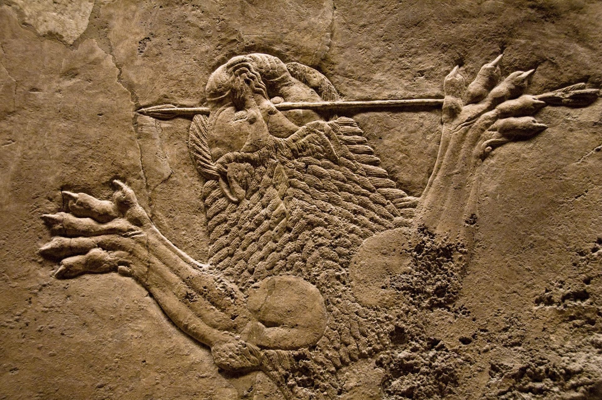 Artistic Assyrian lion-hunt stone relief: a warrior spearing a lion, detailed carved textures — HD PC desktop wallpaper/background.