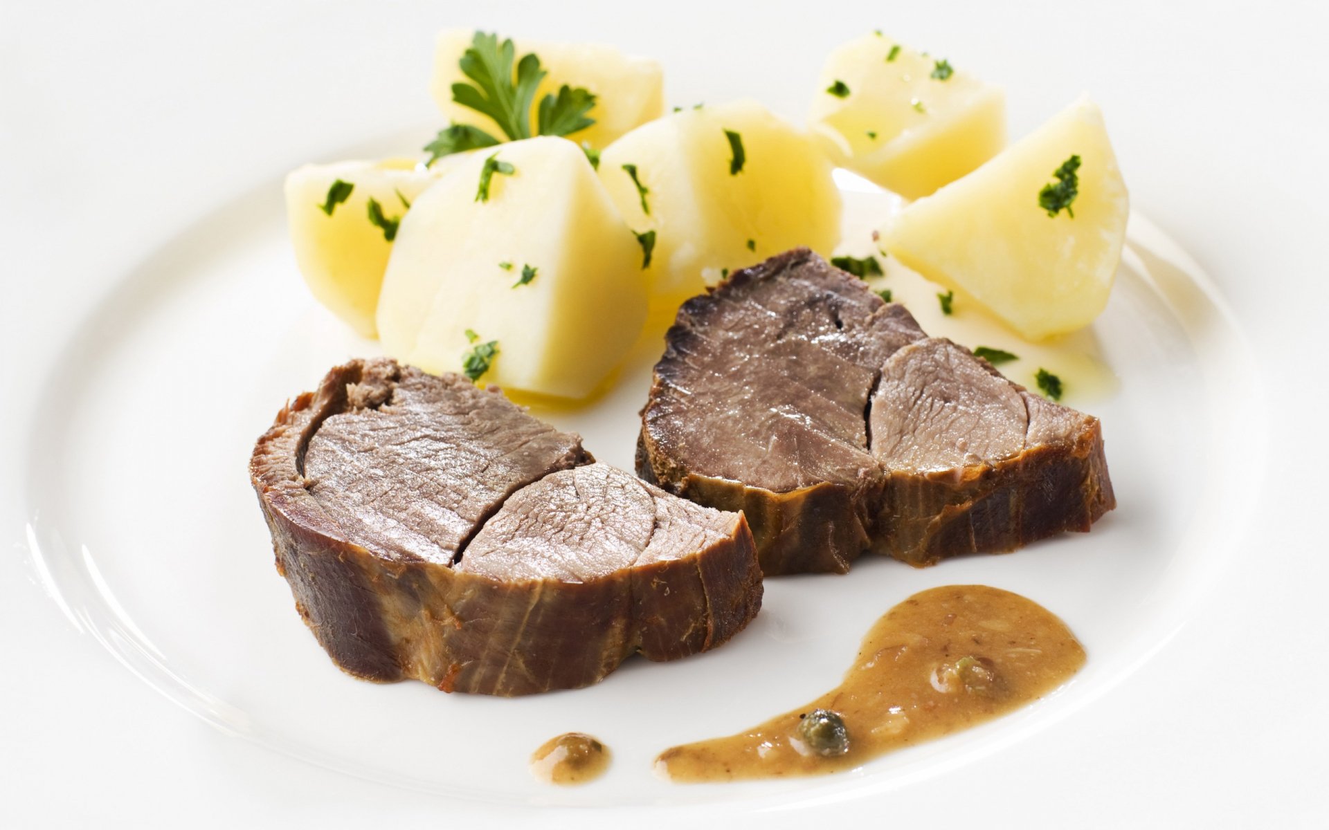 HD desktop wallpaper featuring a plated meal with two slices of cooked meat, garnished boiled potatoes, and a serving of brown sauce on a white plate.