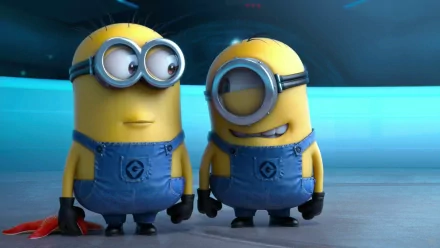HD desktop wallpaper featuring Stuart and Bob from Minions in the movie Despicable Me 2. The cartoon characters are standing in a blue-themed background with their iconic denim overalls.