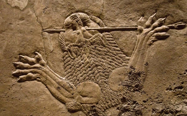 Artistic Assyrian lion-hunt stone relief: a warrior spearing a lion, detailed carved textures — HD PC desktop wallpaper/background.