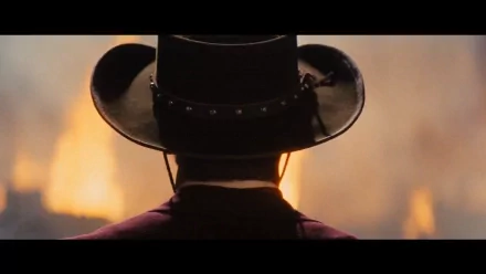 HD PC desktop wallpaper from the movie Django Unchained: a lone hat-wearing figure seen from behind, facing blazing flames.