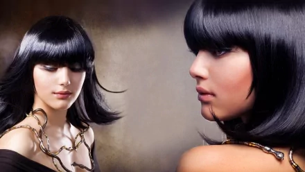 A striking HD desktop wallpaper featuring Anna Subbotina, showcasing a woman's face with sleek black hair and a delicate chain accessory, set against a soft background.