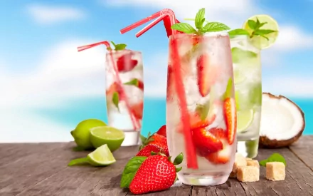 HD PC desktop wallpaper featuring refreshing cocktails with strawberries, lime slices, mint, and ice, set against a bright, clear sky background.