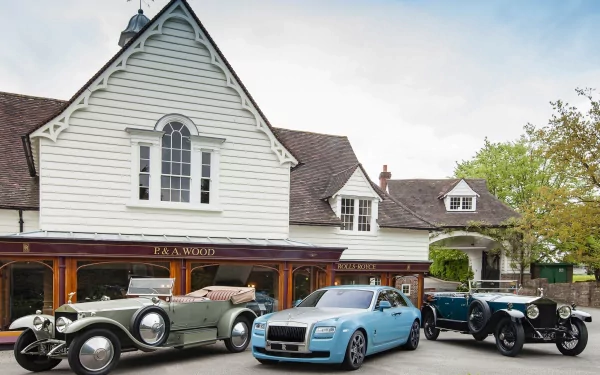 A vintage scene featuring classic and old Rolls-Royce vehicles parked in front of a charming building, creating a stunning HD wallpaper for automotive enthusiasts.