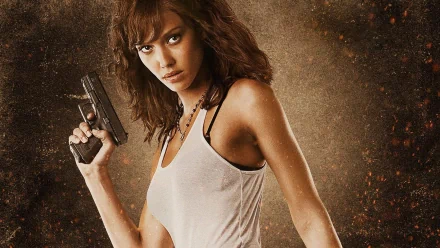 Jessica Alba as a fierce character holding a gun from the movie Machete, featured in a high-definition PC desktop wallpaper and background.