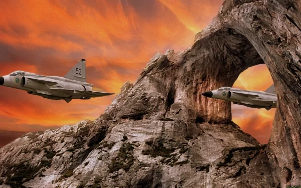 Two military jets fly through a rocky arch, set against a vibrant sunset sky. This striking image serves as a dynamic HD desktop wallpaper, showcasing powerful aircraft in action.