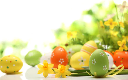 A vibrant Easter-themed desktop wallpaper featuring decorated eggs in various colors, alongside cheerful yellow flowers, set against a soft, bright background.