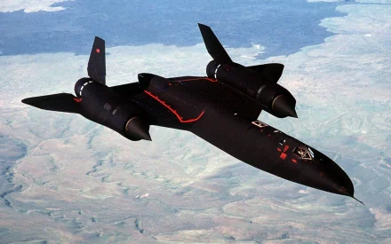 A stunning HD desktop wallpaper featuring the sleek Lockheed SR-71 Blackbird soaring high above a scenic landscape, showcasing its military engineering and aerodynamic design.