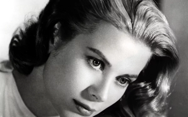 Black-and-white close-up of a glamorous midcentury Hollywood actress, soft waved hair and thoughtful gaze — 2K Quad HD PC desktop wallpaper.