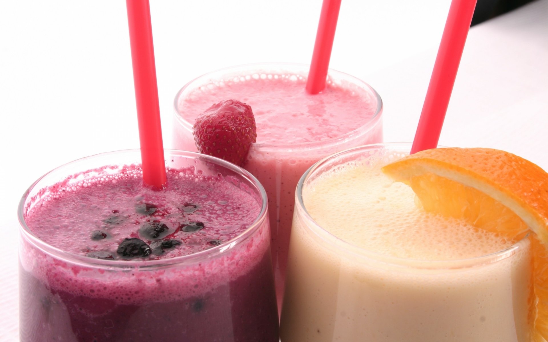 HD PC desktop wallpaper featuring three colorful fruit cocktails with straws, including berry and citrus flavors, set against a bright, clean backdrop.