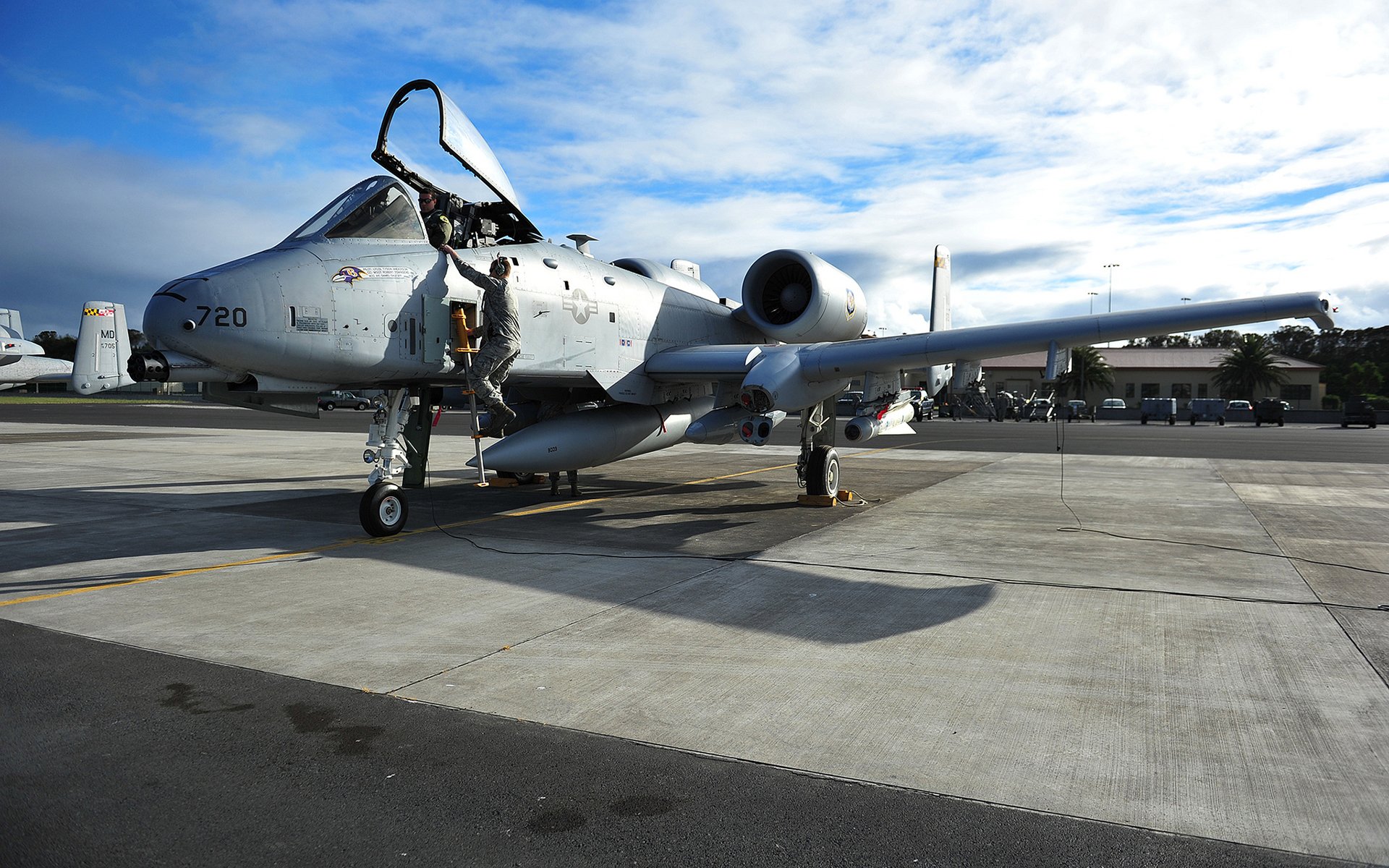 A Fairchild Republic A-10 Thunderbolt II on the tarmac, showcasing its iconic design and ready for action. This HD wallpaper captures the essence of military aviation.