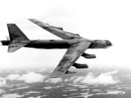 A Boeing B-52 Stratofortress flying over clouds, showcasing its military design. This HD image serves as a striking desktop wallpaper and background.