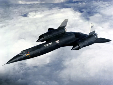 HD desktop wallpaper featuring a Lockheed A-12 military aircraft flying above clouds in a clear sky.