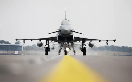 A Eurofighter Typhoon aircraft on the runway, captured in high definition, showcasing its military design and power as it prepares for takeoff.